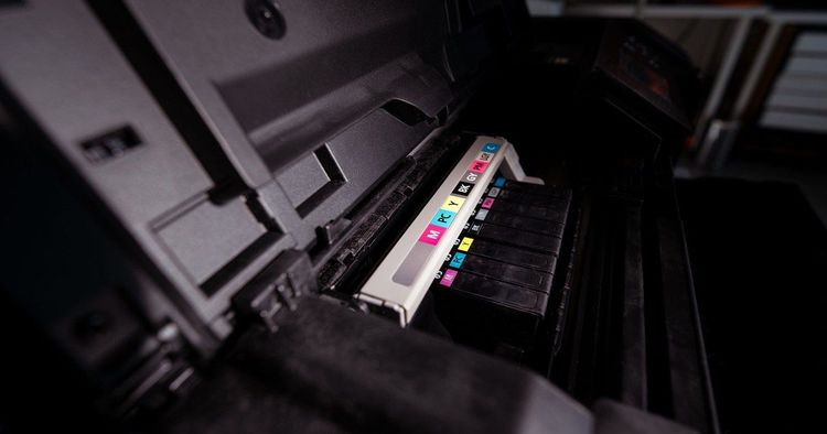 Close-up of a production printer head laying down ink at full print resolution