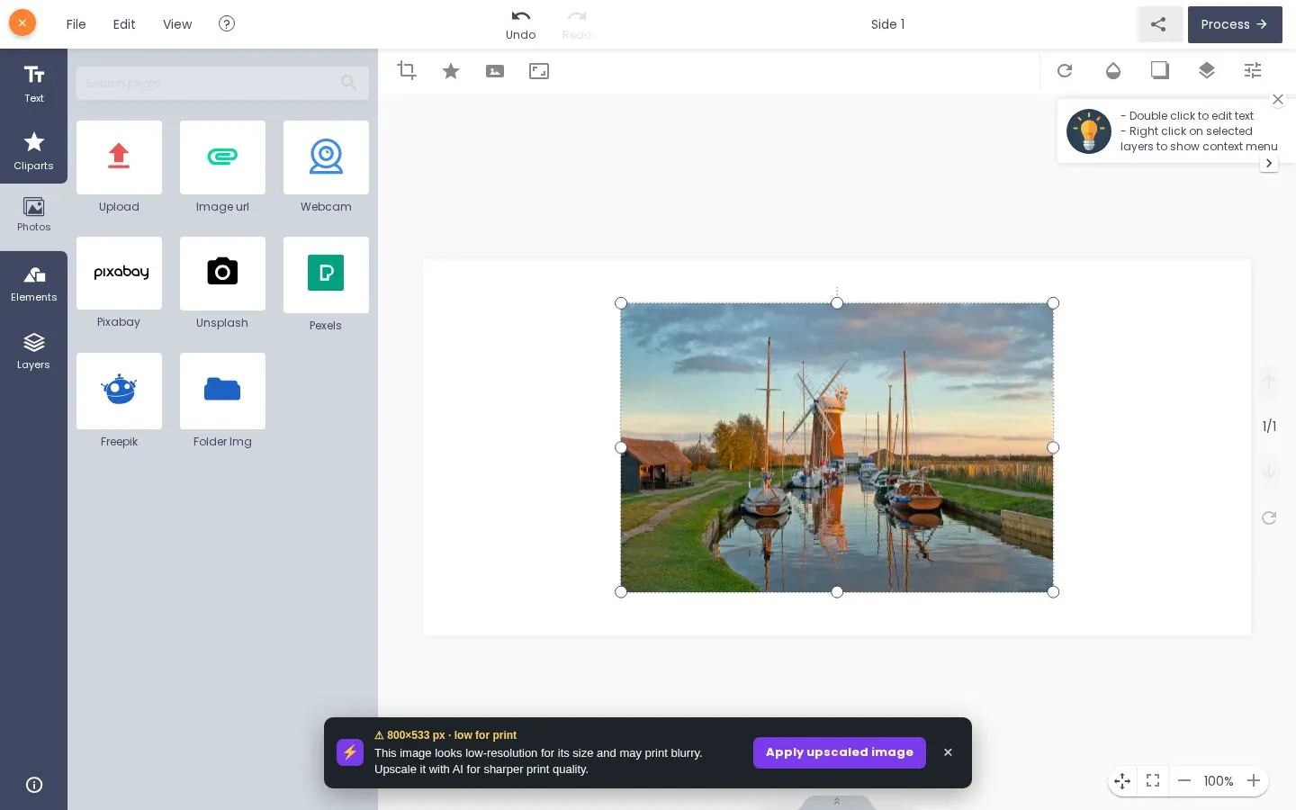 Designer showing the uploaded photo and the message that it looks low-resolution with an Apply upscaled image button